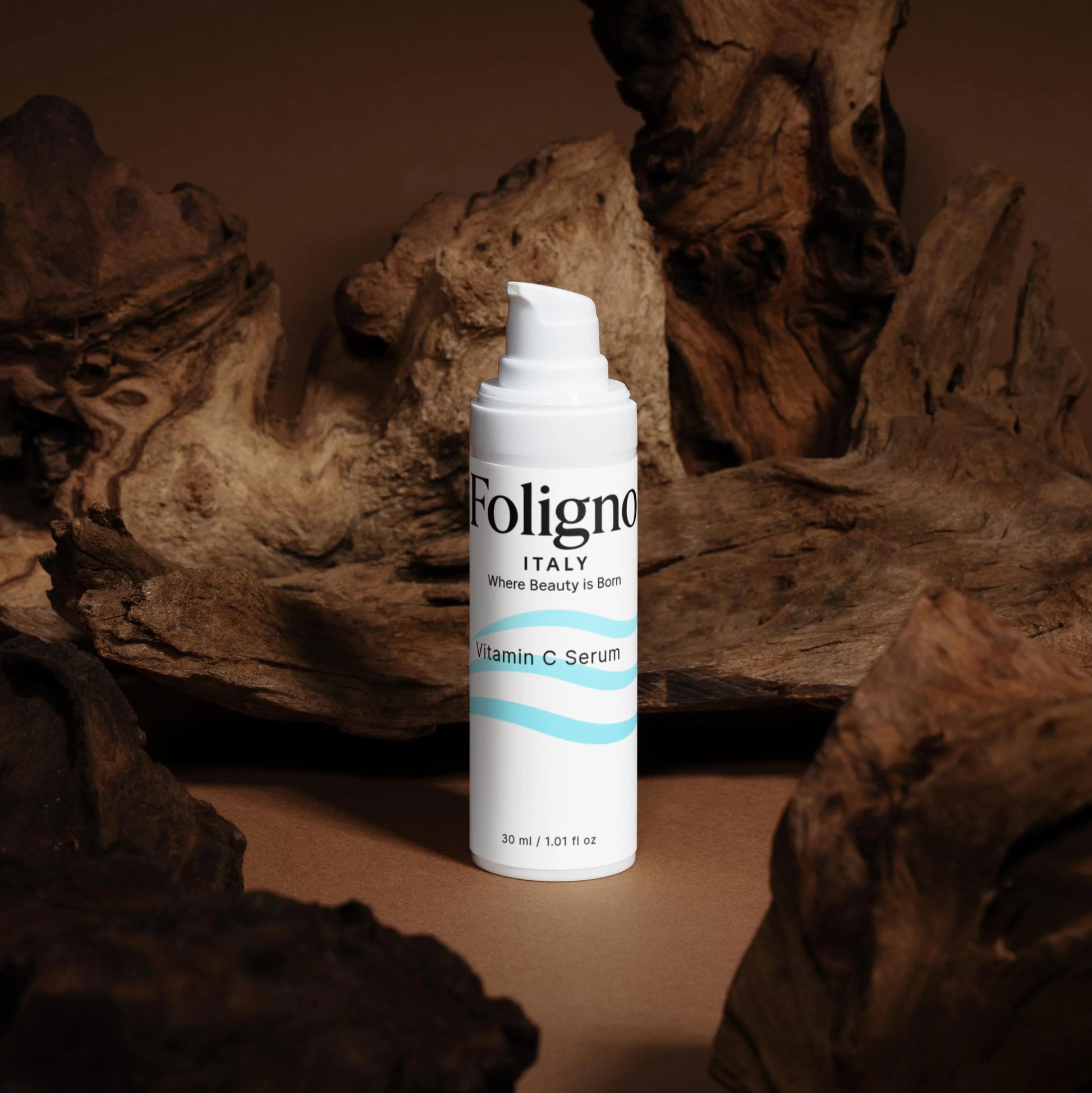 Foligno skincare serum bottle on a textured brown background