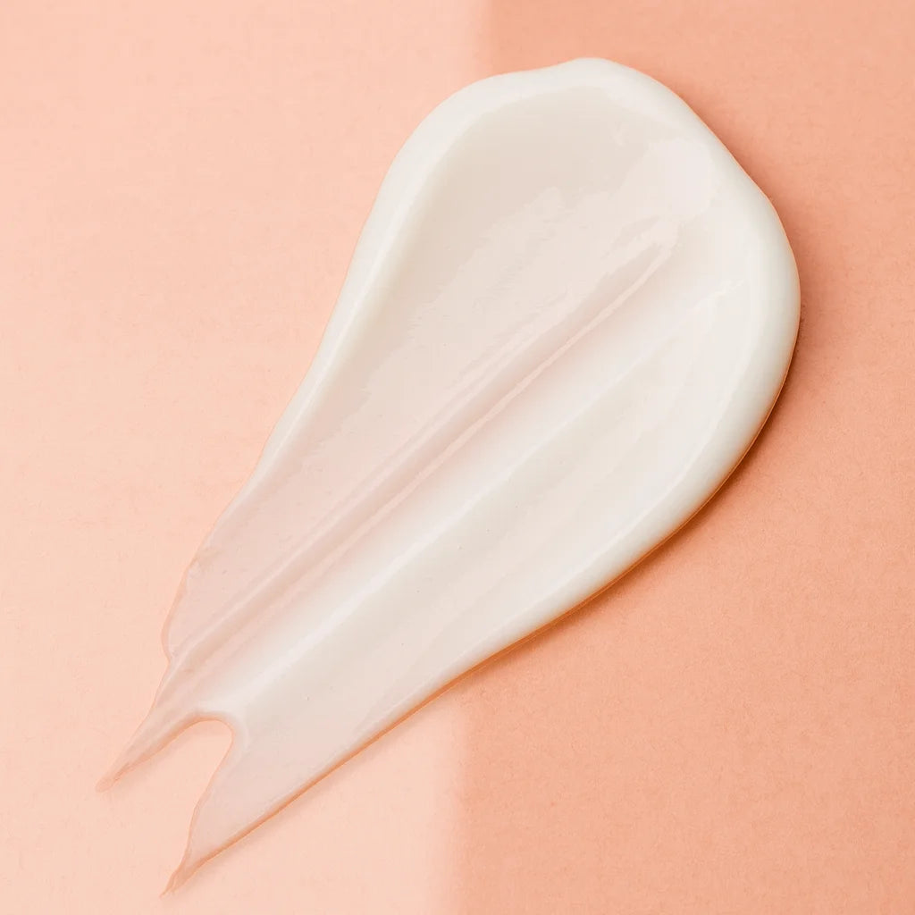 White cream smear on a peach background