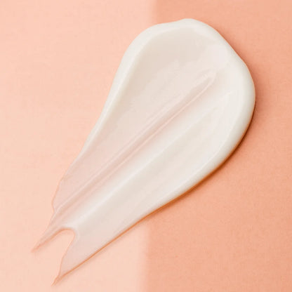 White cream smear on a peach background