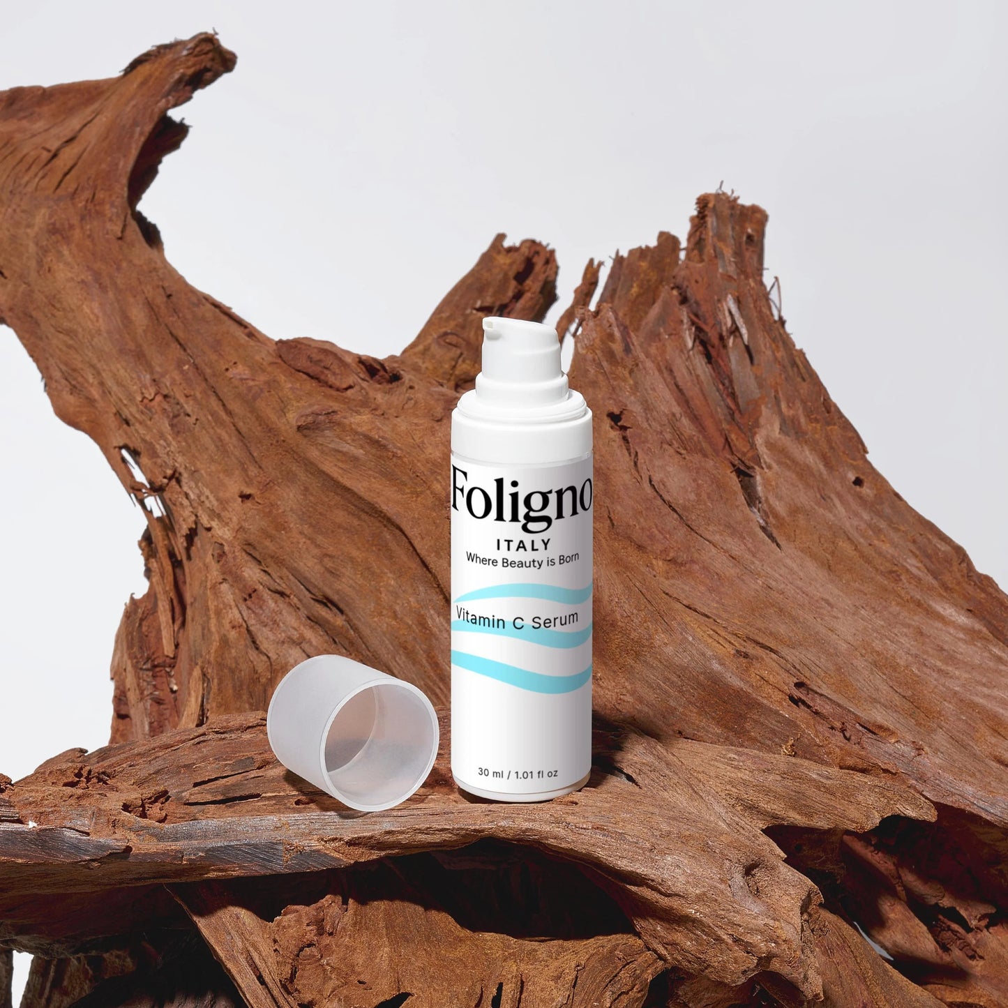 Foligno Vitamin C Serum bottle on a wooden surface