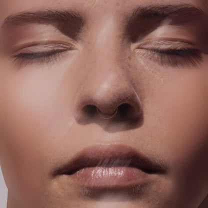 Close-up of a person's face with eyes closed, focusing on the nose and lips.